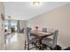 Inviting dining room with sleek tiled floors, an elegant table setting, and sliding glass doors leading to the screened patio at 214 Majors Ln # B, Kissimmee, FL 34743