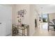 Bright entryway featuring a decorative welcome sign, glass table, and a glimpse into the living area with views of the lake at 214 Majors Ln # B, Kissimmee, FL 34743