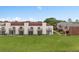 Apartment building with a manicured lawn and multiple balconies, offering pleasant outdoor living spaces at 214 Majors Ln # B, Kissimmee, FL 34743