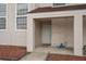 Front door of a house with a covered porch and a hose on the ground at 214 Majors Ln # B, Kissimmee, FL 34743