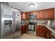Updated kitchen with stainless steel appliances, granite counters, tile backsplash, and wooden cabinetry at 214 Majors Ln # B, Kissimmee, FL 34743