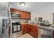 The kitchen features wood cabinets, stainless steel appliances, and decorative backsplash at 214 Majors Ln # B, Kissimmee, FL 34743