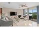Relaxing living room with a comfortable gray sofa, fireplace, and views of the lake at 214 Majors Ln # B, Kissimmee, FL 34743