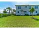 Spacious backyard offers lush lawn and seating space for outdoor relaxation at 224 Nine Iron Dr, Davenport, FL 33896