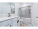 Clean bathroom features a white vanity, gray tiled shower, and modern fixtures at 224 Nine Iron Dr, Davenport, FL 33896
