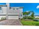Charming townhome featuring a two-car garage, stone facade, and lush landscaping, creating a welcoming curb appeal at 224 Nine Iron Dr, Davenport, FL 33896