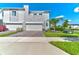 Modern townhome with a two-car garage, stone accents, and well-maintained landscaping, perfect for stylish living at 224 Nine Iron Dr, Davenport, FL 33896