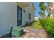 Inviting entryway with a blue front door, brick pathway, and vibrant landscaping, creating a warm welcome at 224 Nine Iron Dr, Davenport, FL 33896