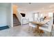 Open-concept living space with tiled floors, staircase, dining area, and kitchen, perfect for modern living and entertaining at 224 Nine Iron Dr, Davenport, FL 33896