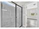 Modern bathroom featuring tiled shower with glass enclosure, sleek fixtures, and a bright, airy feel at 2311 Bear Peak Rd, Clermont, FL 34715
