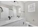 Modern bathroom featuring double sinks, quartz countertops and matte black hardware at 2311 Bear Peak Rd, Clermont, FL 34715