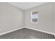 This bedroom has a window offering natural light and features modern gray laminate flooring at 2311 Bear Peak Rd, Clermont, FL 34715