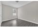 This bedroom has a window offering natural light and features modern gray laminate flooring at 2311 Bear Peak Rd, Clermont, FL 34715