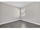 This bedroom has a window offering natural light and features modern gray laminate flooring at 2311 Bear Peak Rd, Clermont, FL 34715