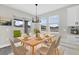 Inviting dining area with a sliding glass door, modern lighting, and seating for six at 2311 Bear Peak Rd, Clermont, FL 34715