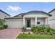 Charming single-Gathering home with a two-car garage, landscaped front yard, and welcoming entryway at 2311 Bear Peak Rd, Clermont, FL 34715