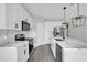 Modern kitchen featuring sleek white cabinets, stainless steel appliances, and a stylish island at 2311 Bear Peak Rd, Clermont, FL 34715
