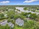 A view of the apartments, lake, tennis court, and parking at 2580 Grassy Point Dr # 106, Lake Mary, FL 32746