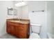 Bathroom features a wood vanity with granite countertop and a large mirror above the sink at 2580 Grassy Point Dr # 106, Lake Mary, FL 32746