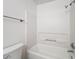 Bathroom featuring white tiled shower and tub combo with updated shower head at 2580 Grassy Point Dr # 106, Lake Mary, FL 32746