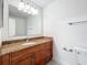 Bathroom features wood vanity, granite countertop, large mirror, and modern lighting at 2580 Grassy Point Dr # 106, Lake Mary, FL 32746