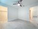Bedroom boasts a ceiling fan, neutral paint, and tile flooring, with a walk-in closet at 2580 Grassy Point Dr # 106, Lake Mary, FL 32746