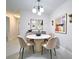 Modern dining room with marble table, plush chairs, and stylish wall art at 2580 Grassy Point Dr # 106, Lake Mary, FL 32746