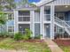 Two-story condo with a screened porch and white stair rails at 2580 Grassy Point Dr # 106, Lake Mary, FL 32746