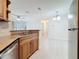 Modern kitchen with stone countertops, stainless steel appliances and view into the dining area at 2580 Grassy Point Dr # 106, Lake Mary, FL 32746