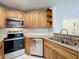 Well-equipped kitchen with stainless steel appliances and ample cabinet space at 2580 Grassy Point Dr # 106, Lake Mary, FL 32746