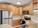 Bright kitchen with stainless steel appliances, tiled backsplash, and updated fixtures at 2580 Grassy Point Dr # 106, Lake Mary, FL 32746