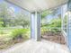 Screened-in patio with neutral tile flooring and a view of the landscaped yard at 2580 Grassy Point Dr # 106, Lake Mary, FL 32746
