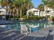 Resort-style pool with lounge chairs and tropical landscaping at 2580 Grassy Point Dr # 106, Lake Mary, FL 32746