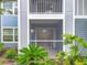 Close up of screened in porch with sliding glass door and lush landscaping at 2580 Grassy Point Dr # 106, Lake Mary, FL 32746