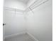 Empty walk-in closet with metal shelving and tile floors at 2580 Grassy Point Dr # 106, Lake Mary, FL 32746