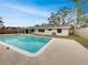 Backyard features a refreshing swimming pool, patio, and view of the home's exterior at 2710 Wyndham Ln, Orlando, FL 32808