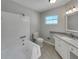 Bright bathroom with a tub-shower combo, granite countertop vanity, and modern fixtures at 2710 Wyndham Ln, Orlando, FL 32808