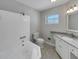 Bathroom featuring a white vanity with granite countertop and tiled shower with tub at 2710 Wyndham Ln, Orlando, FL 32808