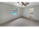 Bedroom with a view of the pool from the window and a doorway to a bathroom at 2710 Wyndham Ln, Orlando, FL 32808