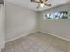 Bedroom with ceiling fan and tile floors, featuring a view from the window at 2710 Wyndham Ln, Orlando, FL 32808