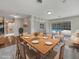 Staged dining room with a modern table setting and a view of the pool through sliding glass doors at 2710 Wyndham Ln, Orlando, FL 32808