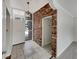 Inviting entryway with tiled floors, white door, and a charming brick accent wall at 2710 Wyndham Ln, Orlando, FL 32808