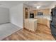 Open kitchen area with light wood cabinets, an island, and a view into an adjacent living space at 2710 Wyndham Ln, Orlando, FL 32808