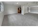 Spacious living room with gray carpet, white walls and trim, and views of the kitchen at 2710 Wyndham Ln, Orlando, FL 32808