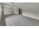 Bright, open living room with neutral gray carpet and freshly painted walls at 2710 Wyndham Ln, Orlando, FL 32808