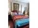 Well-lit bedroom featuring a four-post bed with colorful bedding and classic decor at 2922 Burlington Dr, Apopka, FL 32703