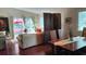 Cozy dining area adjacent to the living room with rich wood flooring at 2922 Burlington Dr, Apopka, FL 32703