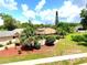 Inviting single-story home surrounded by lush greenery, palm trees and vibrant landscaping at 2922 Burlington Dr, Apopka, FL 32703