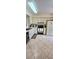 Functional kitchen with neutral cabinetry, white appliances and tile flooring at 2922 Burlington Dr, Apopka, FL 32703