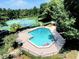 Community pool with tennis courts, lounge chairs and an inflatable float in a well-maintained community at 2922 Burlington Dr, Apopka, FL 32703